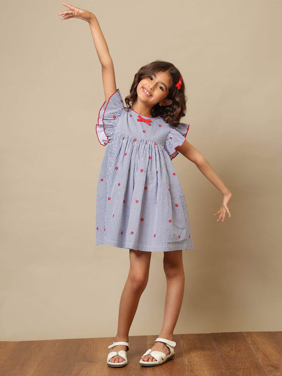 Blue striped girls printed dress with ruffle sleeves, gathered waist and red bow detailing