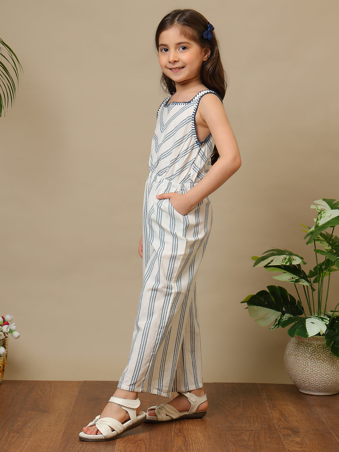 Blue and white striped girls sleeveless jumpsuit with wide-leg pants and chevron pattern
