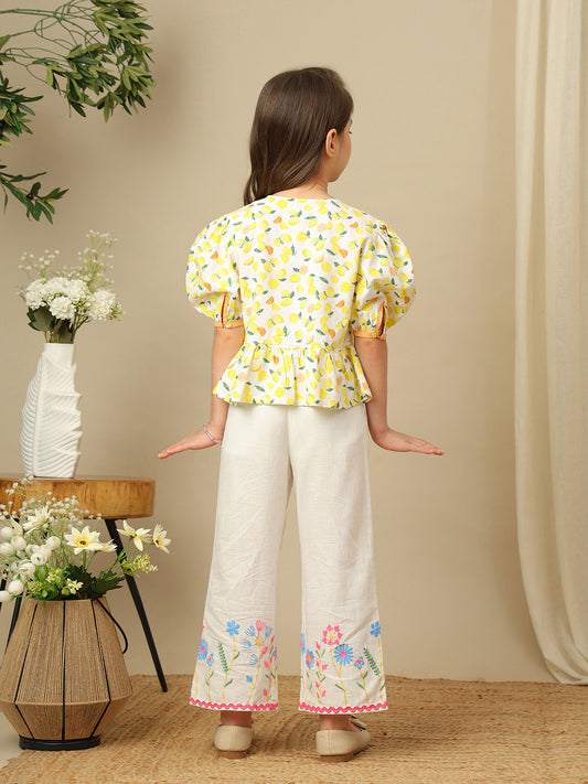 Girls lemon print cotton top with puff sleeves, contrast bow detailing and gathered peplum hem.