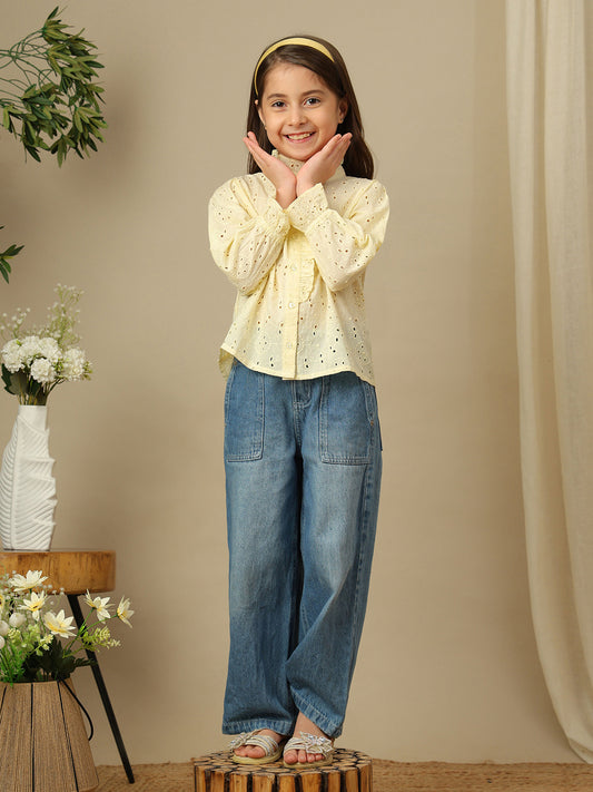 Girls yellow cotton Schiffli shirt with all-over eyelet embroidery, ruffled high neckline, button front and long sleeves.