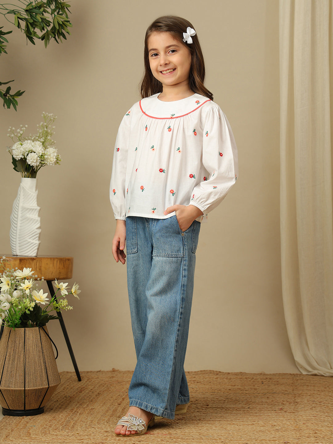 Girls white cotton shirt with red floral embroidery, green leaf detailing, collared neck, button-down front and full sleeves.