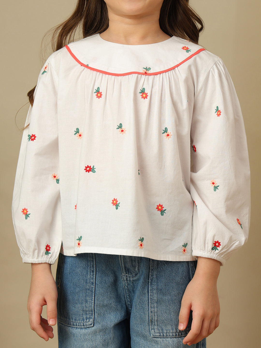 Girls white cotton shirt with red floral embroidery, green leaf detailing, collared neck, button-down front and full sleeves.