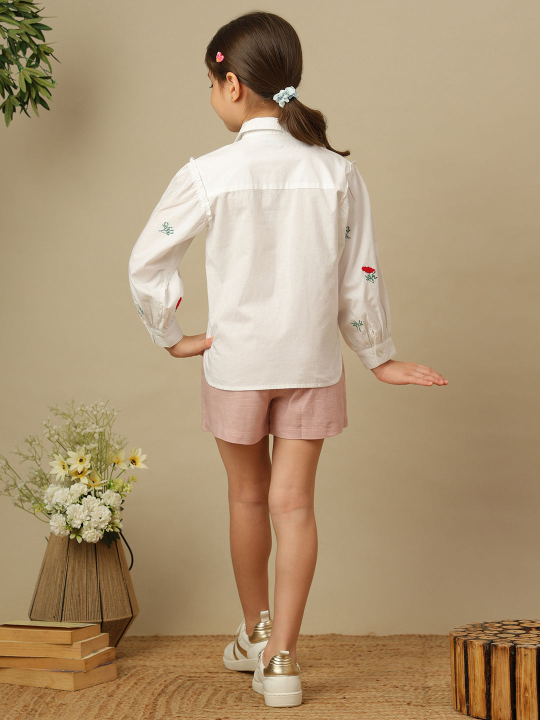 Girls white cotton shirt with red floral embroidery, green leaf detailing, collared neck, button-down front and full sleeves.