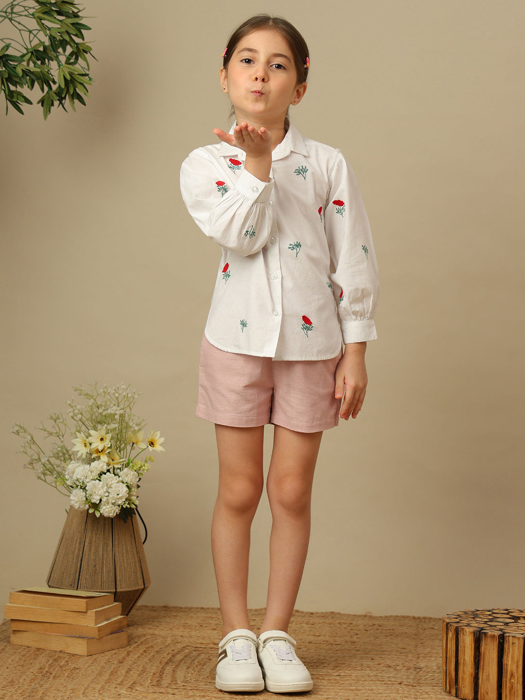 Girls white cotton shirt with red floral embroidery, green leaf detailing, collared neck, button-down front and full sleeves.