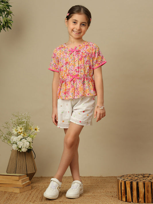 Girls floral print cotton top with bow detailing, short sleeves, pintucks and gathered peplum hem.