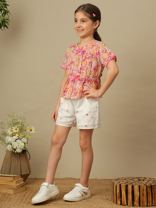 Girls floral print cotton top with bow detailing, short sleeves, pintucks and gathered peplum hem.