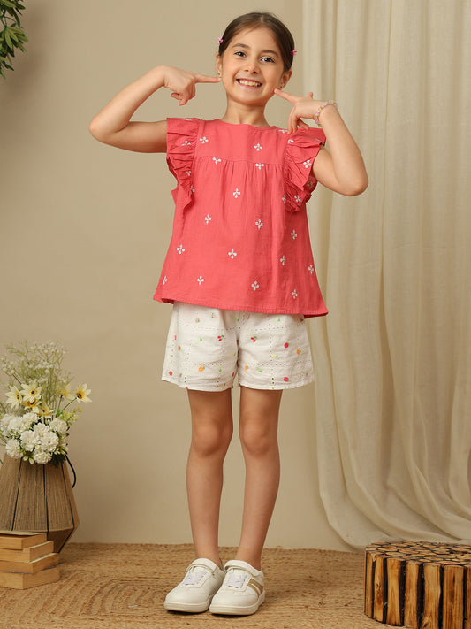 Girls coral cotton top with white floral embroidery, gathered yoke and layered ruffle sleeves.