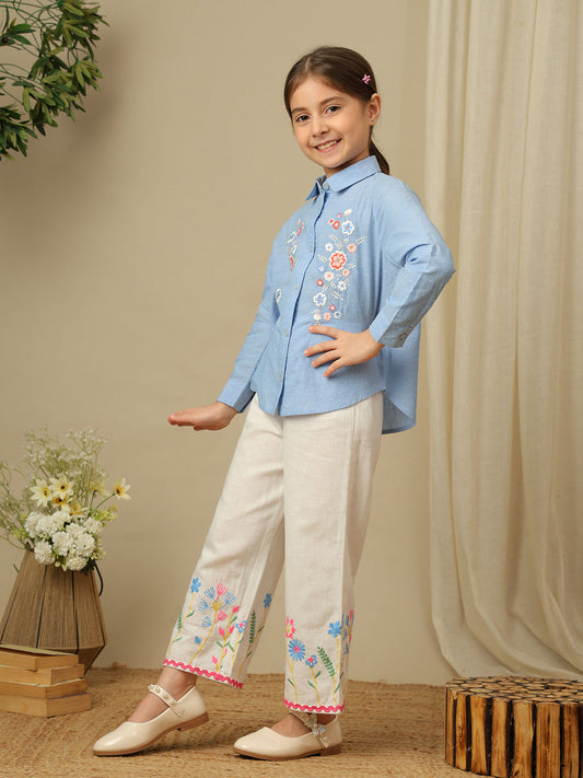 Girls blue cotton shirt with multicolour floral embroidery, classic collar, button-down front and full sleeves.