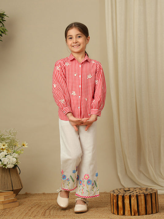 Girls red and white checked cotton shirt with floral embroidery, collared neck, button-down front and full puff sleeves.