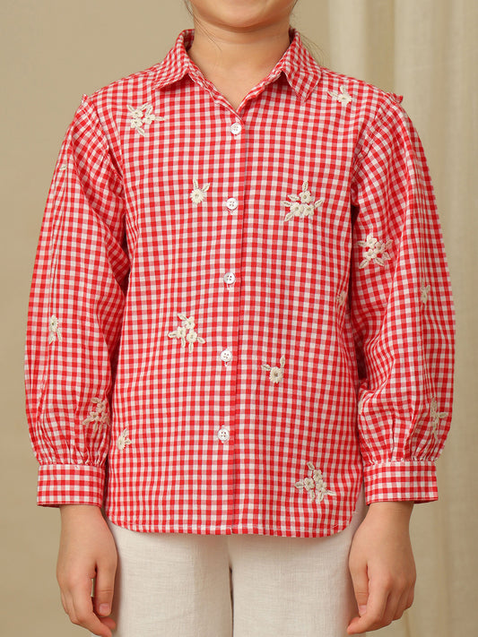 Girls red and white checked cotton shirt with floral embroidery, collared neck, button-down front and full puff sleeves.
