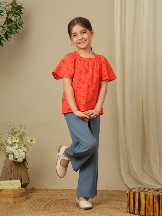 Girls cotton top with floral eyelet embroidery, gathered neckline and flutter sleeves.