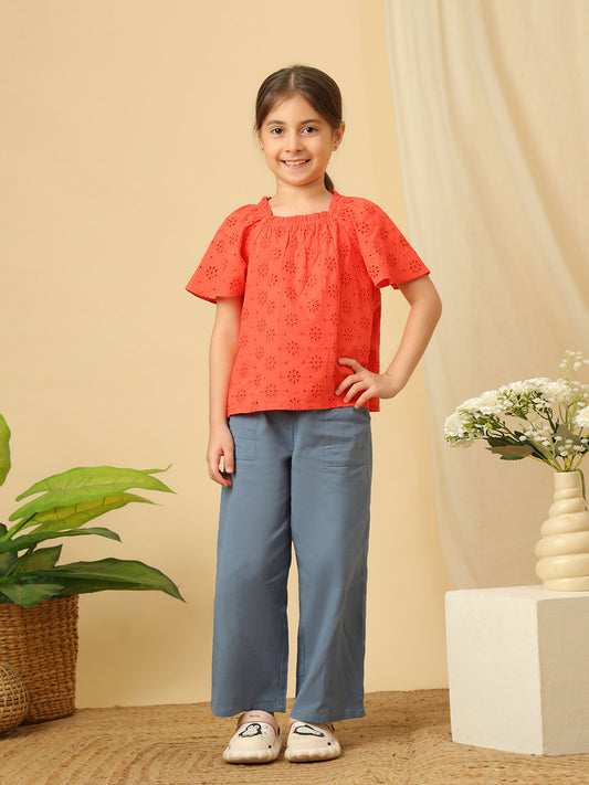 Girls cotton top with floral eyelet embroidery, gathered neckline and flutter sleeves.