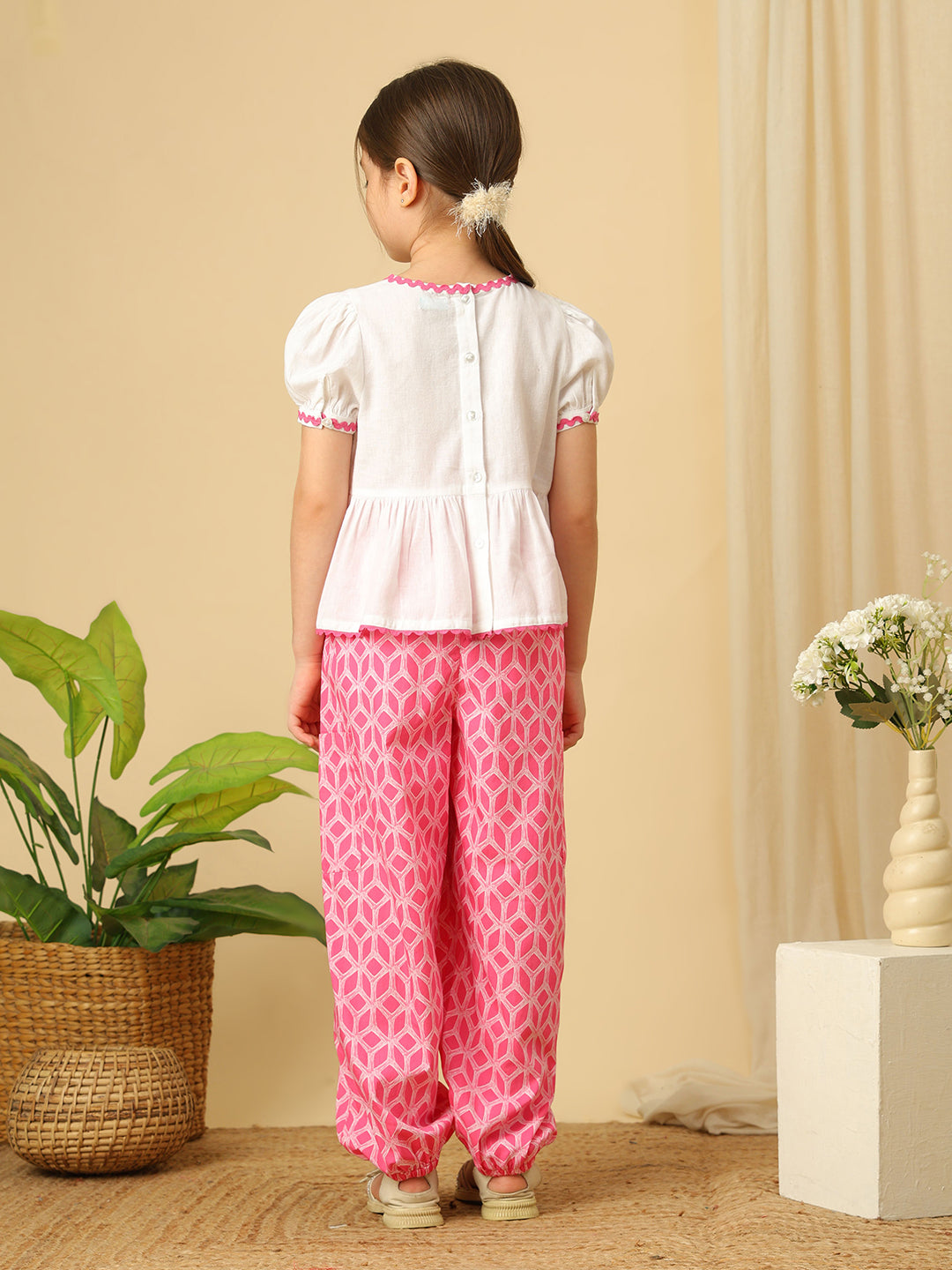 Girls pink and off-white floral embroidered co-ord set with puff sleeve peplum top and geometric print jogger pants
