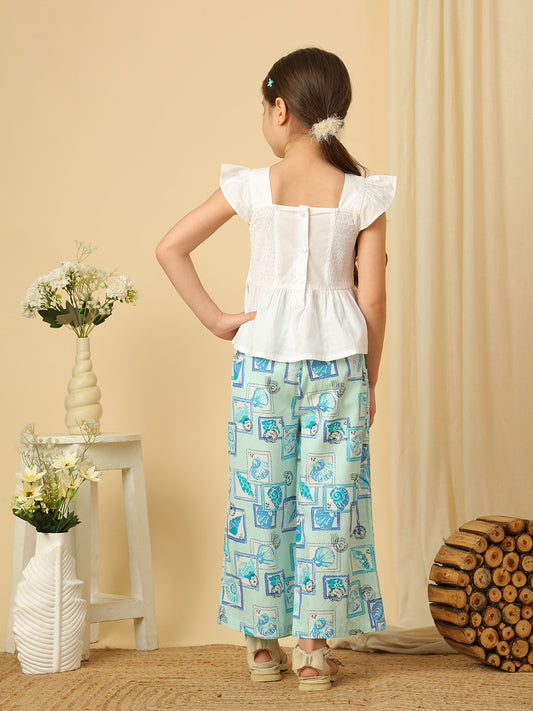 Girls white peplum top with blue seashell and fish embroidery, paired with marine print wide-leg pants co-ord set