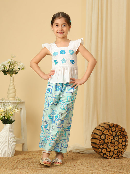 Girls white peplum top with blue seashell and fish embroidery, paired with marine print wide-leg pants co-ord set