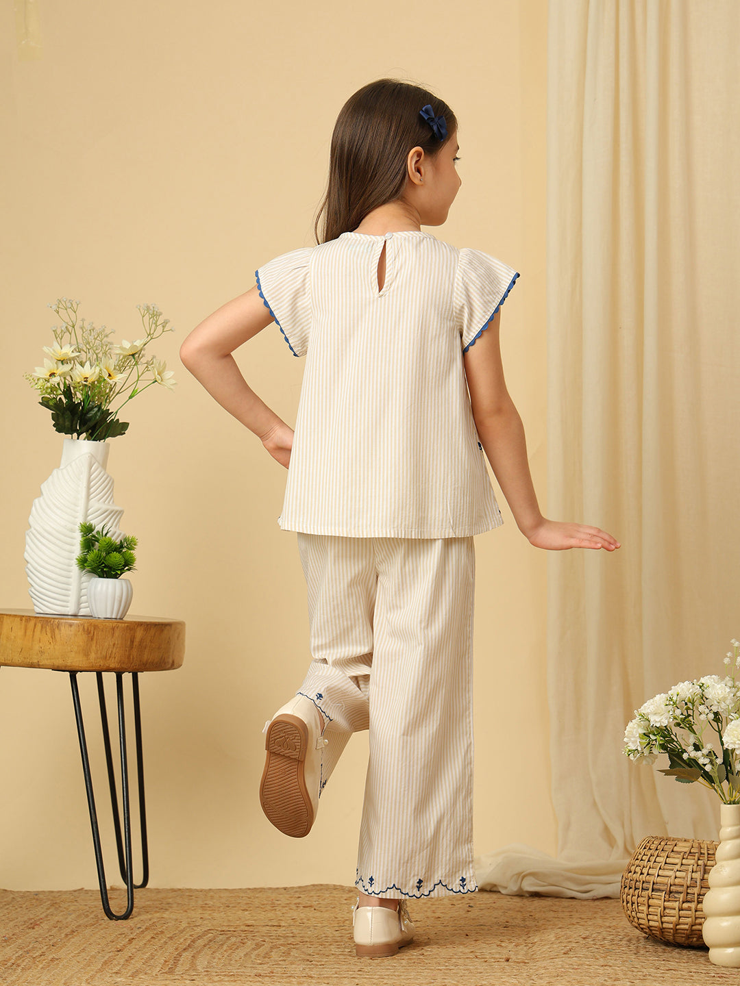 Girls off-white cotton co-ord set with black bow detailing and floral embroidered scalloped hems